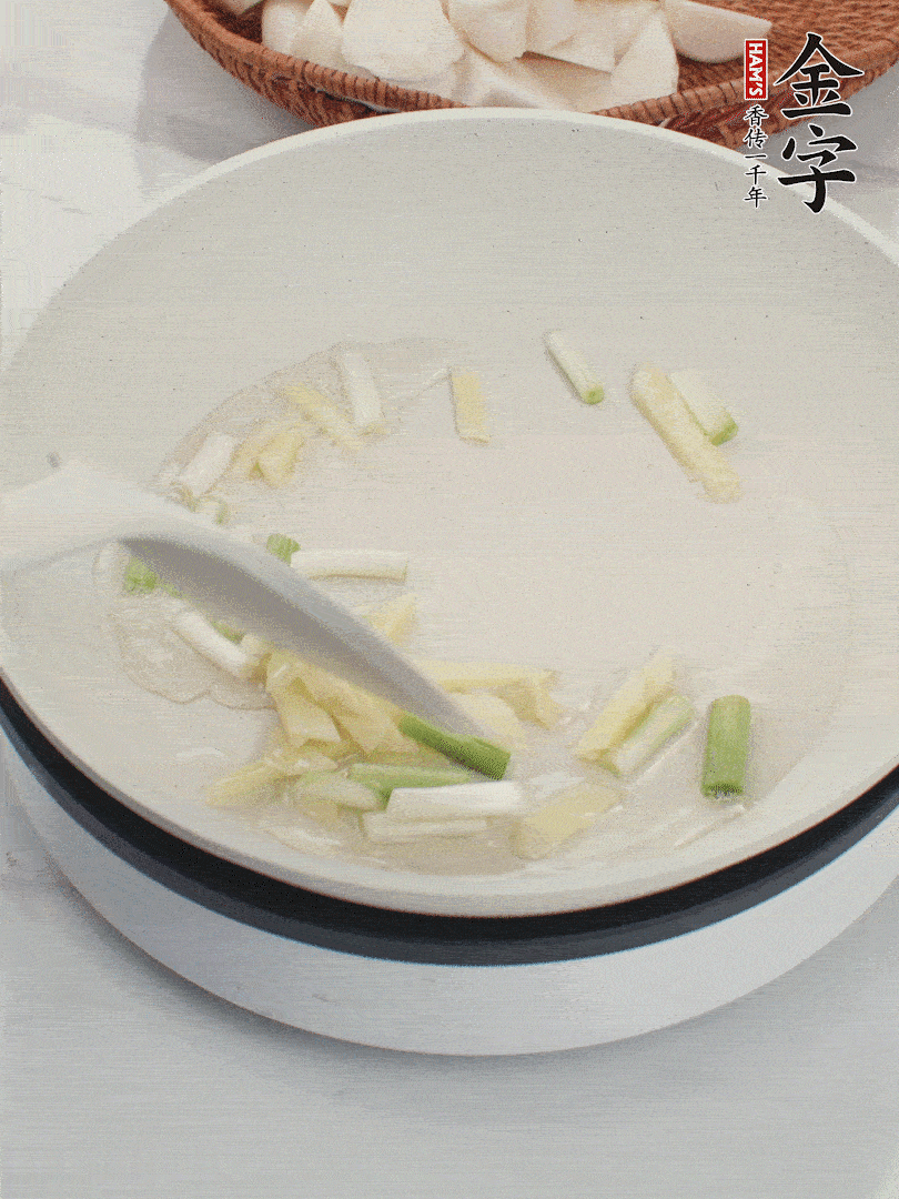 鍋中油五成熱，下蔥白、姜片爆香。