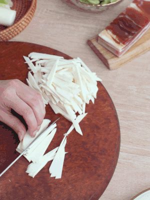 茭白切細(xì)絲，鹽水中浸泡防止氧化。